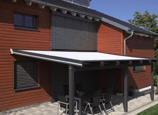 Terrassenvordach mit dunklen Trägerbalken und darüber ausgefahrener Markise.