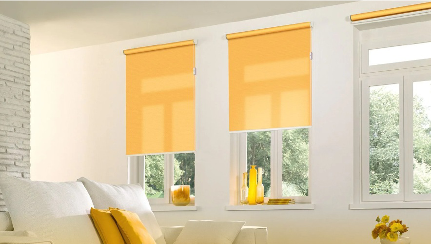 Gelbe Rollos innen an drei gleich großen Fenstern.